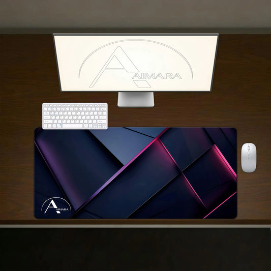 Top-down view of AIMARA abstract purple geometric desk mat on a wooden desk with a white keyboard and mouse.